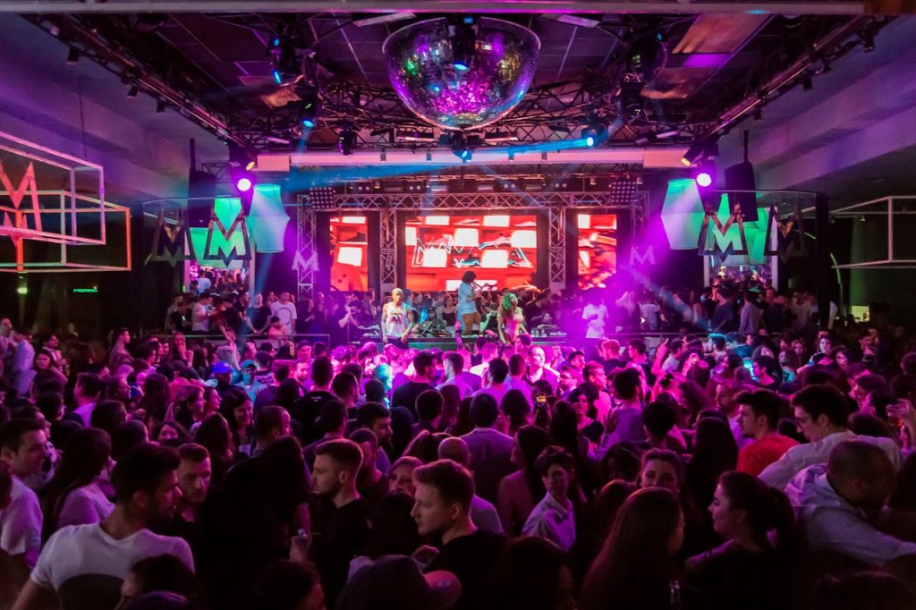 people-inside-a-club-2034851 Dynamic crowd at a lively nightclub in Mantua, Italy, with vibrant lights and energetic atmosphere.